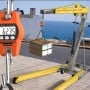 Pèse-bagages électronique suspendu à une grue mobile jaune, affichant un poids de 62,35 kg.