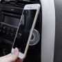 Porte objet rond en silicone fixé sur une grille d'aération de voiture tenant un téléphone mobile.