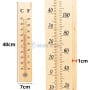 Thermomètre mural en bois clair de 40 cm, affichage des températures en °C et °F de -40 à +50 °C.